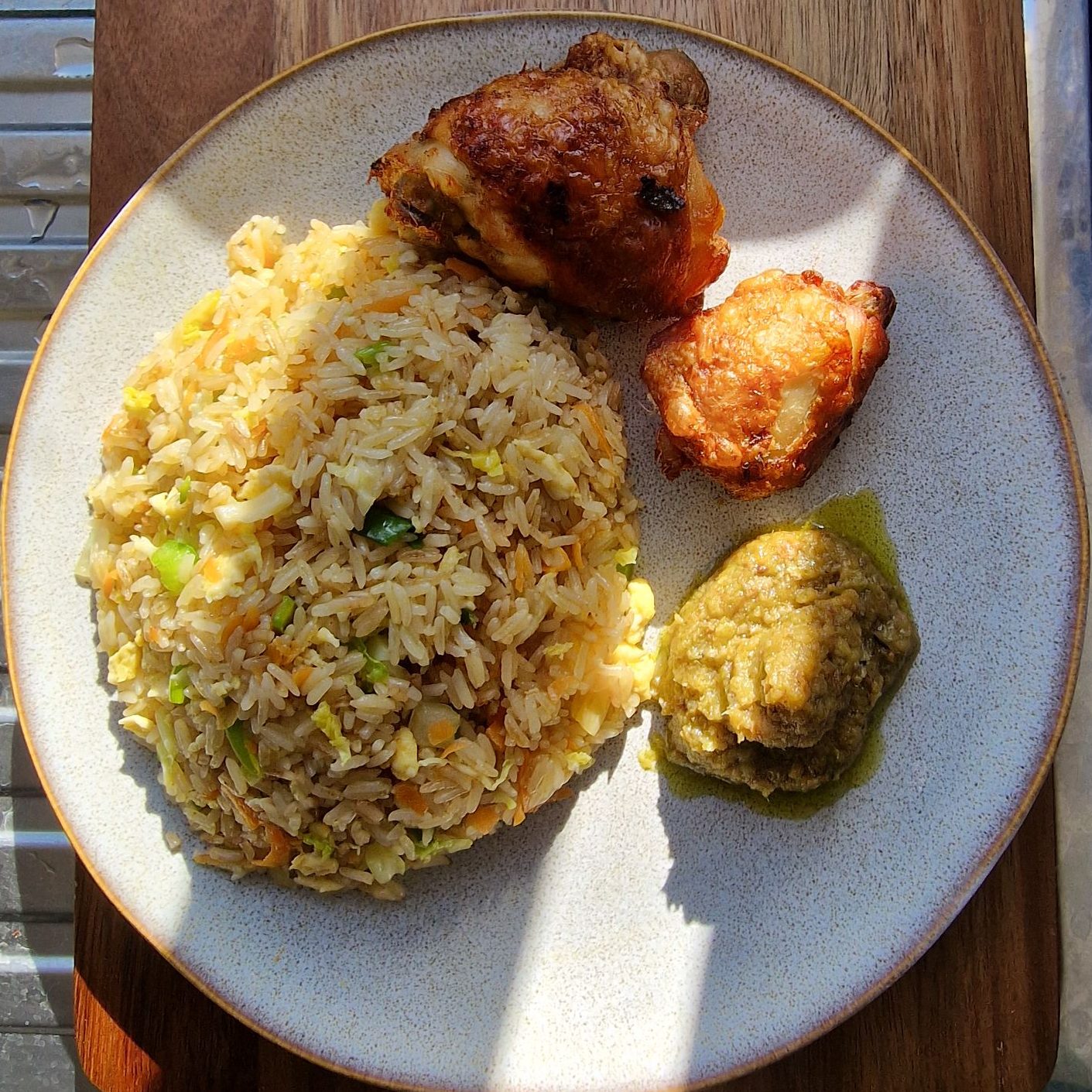 Ghana fried rice with fried chicken thighs
